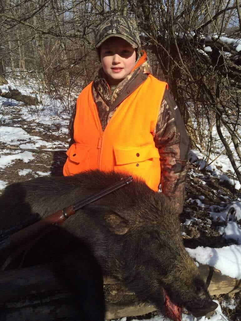 Young Boy with a wild pig