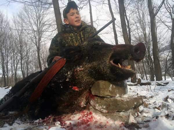 Proud Young Hunter with Trophy Russian Boar at PA's Stonebridge Hunting Preserve